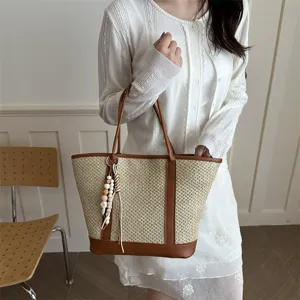 Women summer straw woven shoulder bag with leather trim and wooden bead pendant for daily use