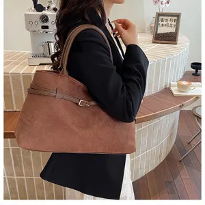 Spacious brown shoulder tote bag for women, elegant commuter handbag with chic belt design.