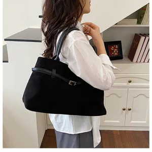 Close-up of the black commuter shoulder tote bag, showcasing large capacity and sleek belt detail.