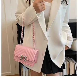 Pink quilted shoulder bag with chain strap and bow detail for women fashion style.