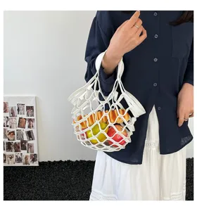 Detail view of the white leather net handbag showcasing hollow design and casual style.