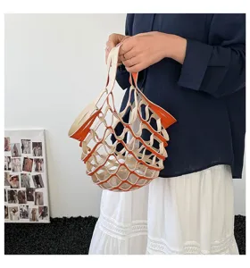 Detailed view of trendy leather mesh handbag in color block design with portable structure.