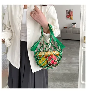 Detailed view of green leather mesh tote bag, minimalist lightweight casual handbag design.