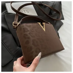Borsa a tracolla con stampa leopardata marrone, vista dettagliata con chiusura a V in metallo.