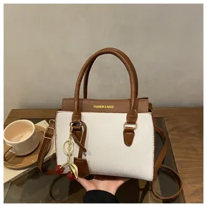 Stylish color block tote bag for women, chic crossbody shoulder handbag with cherry charm.