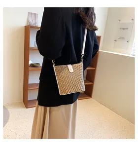 Chic summer straw bucket bag with leather trim and shoulder strap for women fashion style.