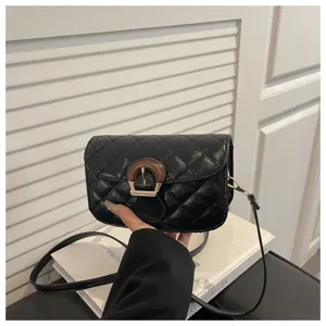 Black quilted crossbody bag detail featuring elegant retro wooden buckle finish.