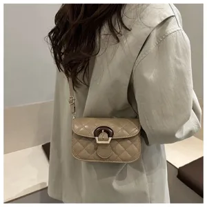 Close-up detail shot of the elegant quilted crossbody shoulder bag with unique wooden buckle.