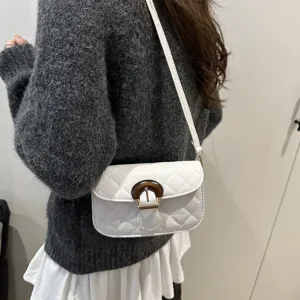 Chic quilted shoulder bag with unique wooden buckle, stylish underarm and crossbody design.