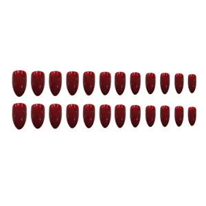 Set de uñas postizas rojas brillantes con forma almendrada y puntas stiletto afiladas.