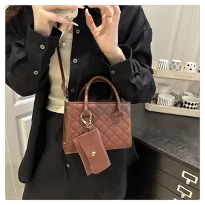 Detailed view of women's stylish quilted brown crossbody handbag with coin purse.