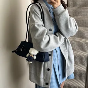 Sweet denim shoulder underarm bag with chic belt buckle and cute bear charm for women.