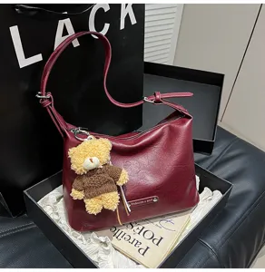 Wine red leather hobo shoulder bag with cute teddy bear charm for women daily fashion style.