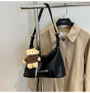 Black faux leather shoulder hobo bag with cute plush bear charm for women daily