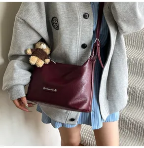 Early autumn stylish wine red underarm shoulder bag detail, chic niche design for women.