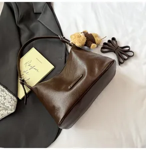 Dark brown PU leather underarm shoulder bag detail, stylish autumn daily handbag with charm.