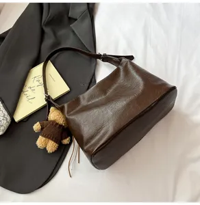 Dark brown leather shoulder bag for women, retro hobo underarm bag with cute bear charm.