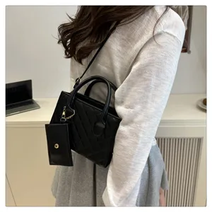 Stylish black quilted handbag with small pouch, casual top handle crossbody bag for women.