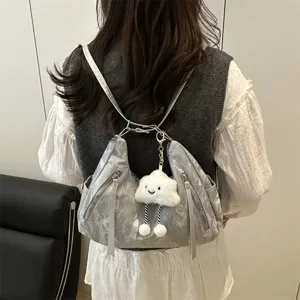 Stylish silver casual shoulder backpack with cute cloud plush pendant for women travel commuting.