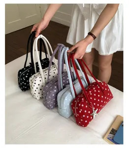 Cute polka dot pillow shoulder bag for women, stylish handbag with dual handles and zipper.