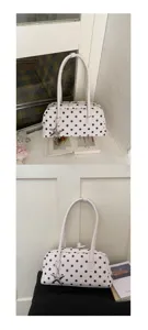 White polka dot shoulder bag for women, stylish handbag with metal star pendant, chic retro design.