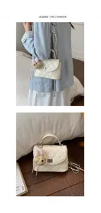 Detail shot of white quilted chain crossbody bag with cute teddy bear plush pendant charm.