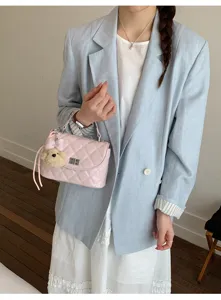 Chic quilted women's shoulder bag with cute bear pendant, stylish crossbody purse for daily.