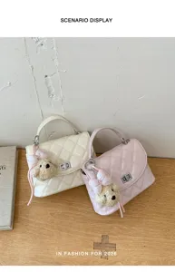Detailed view of stylish quilted women shoulder handbag with cute plush bear pendant.