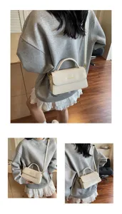 Détail de sac bandoulière blanc chic, sac à main en cuir de qualité avec poignée et finitions.