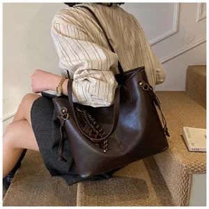Detailed view of women's large capacity brown leather commuting tote bag for daily style.
