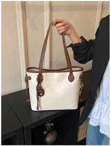 Elegant white tote bag with brown trim, large capacity commuter shoulder bag for women.