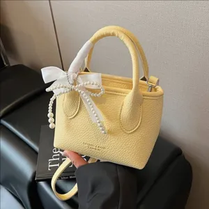 Donna Moda Tinta Unita Pelle PU Borsa a Secchiello Minimalista Borsa a Mano Elegante Fiocco di Perle Borsa a Tracolla