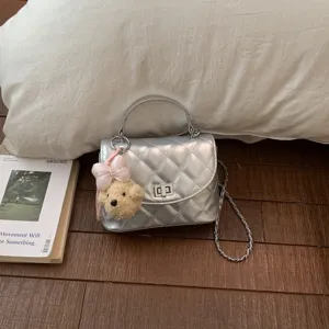 Silver quilted chain crossbody bag with cute bear pendant, stylish compact shoulder bag for women.