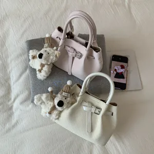 Chic woven textured handbag for women, stylish tote bucket bag with cute bear pendant.