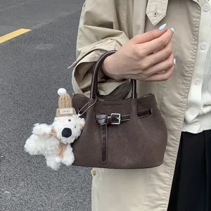 Stylish textured small handbag for women, chic pleated bucket bag with cute bear pendant.
