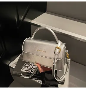 Silver top handle bag for women, stylish leather shoulder messenger bag with metal buckle.