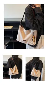 Retro suede shoulder bag detail showing beige underarm tote with bead pendant, brown strap.