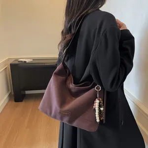 Retro suede shoulder bag for women, casual autumn hobo tote with chic beaded charm.