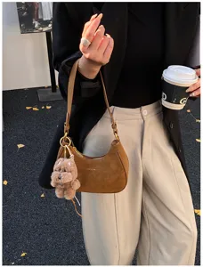 Stylish brown suede shoulder bag for women, chic hobo armpit bag with cute puppy pendant.
