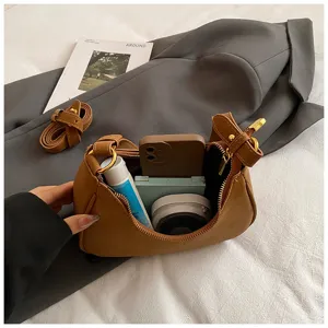 Womens brown suede underarm dumpling shoulder bag detail view showing inner capacity.