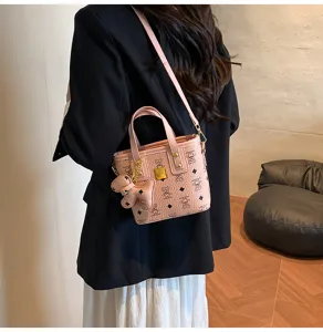 Pink retro bucket handbag with cute bear monogram pattern, elegant crossbody tote bag.