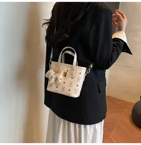 Detailed shot of a chic retro bucket bag with cute bear monogram pattern for daily commute.