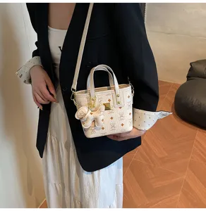 Korean style vintage bucket bag with monogram pattern and cute puppy pendant for women chic.