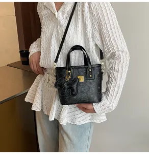Black vintage bucket shoulder bag with top handle, chic retro design for women and daily commute.