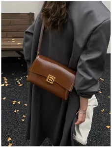 Borsa a tracolla classica in pelle marrone lucida con elegante chiusura geometrica dorata.
