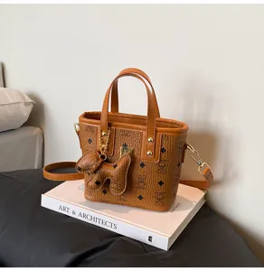 Retro brown bucket bag with cute bear pattern, vintage style leather crossbody handbag.