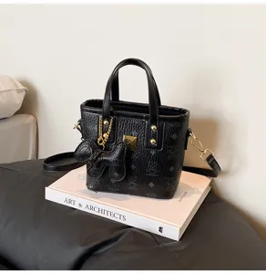 Black vintage textured bucket bag with cute bear monogram pattern, top handle and strap.