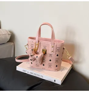 Detailed view of the pink retro bucket bag with cute bear print, stylish PU leather crossbody.