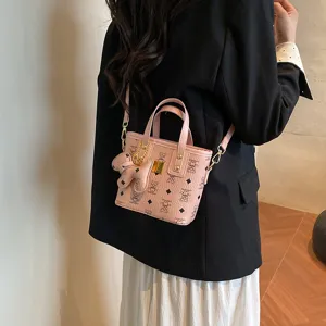 Stylish pink bucket bag with cute bear charm, Korean vintage design for women commuting.