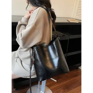 Large capacity bucket bag for women, stylish black PU leather shoulder crossbody bag.